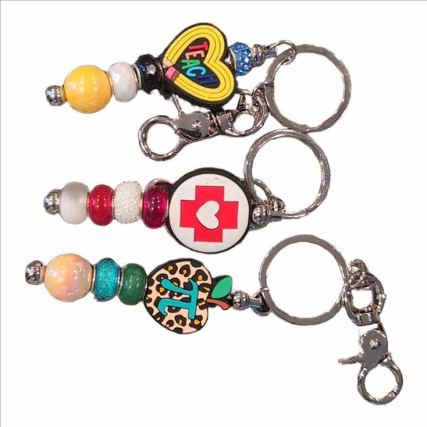 A set of four key chains with different designs.